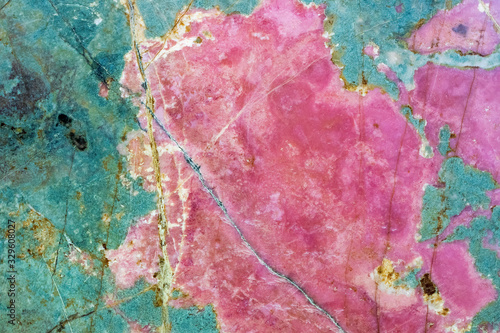 Rhodonite pink massive. Close-up of manganese inosilicate marble like surface photo