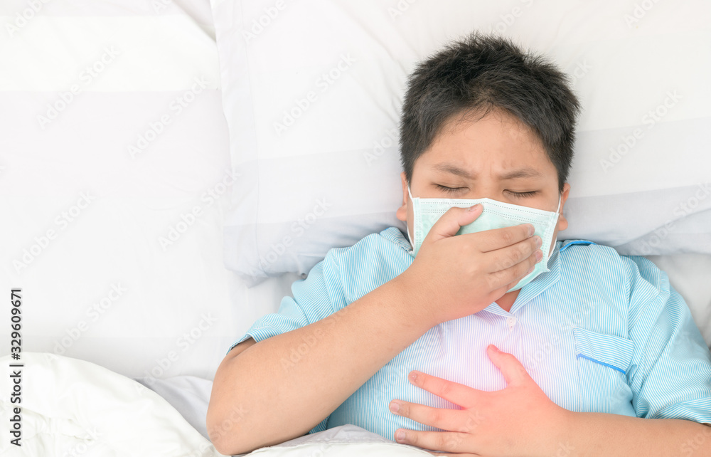 Asian fat boy wear hygienic mask is.coughing and chest pain (red spot) on top view, Asian fat boy wear hygienic mask is.coughing and chest pain (red spot) on top view,