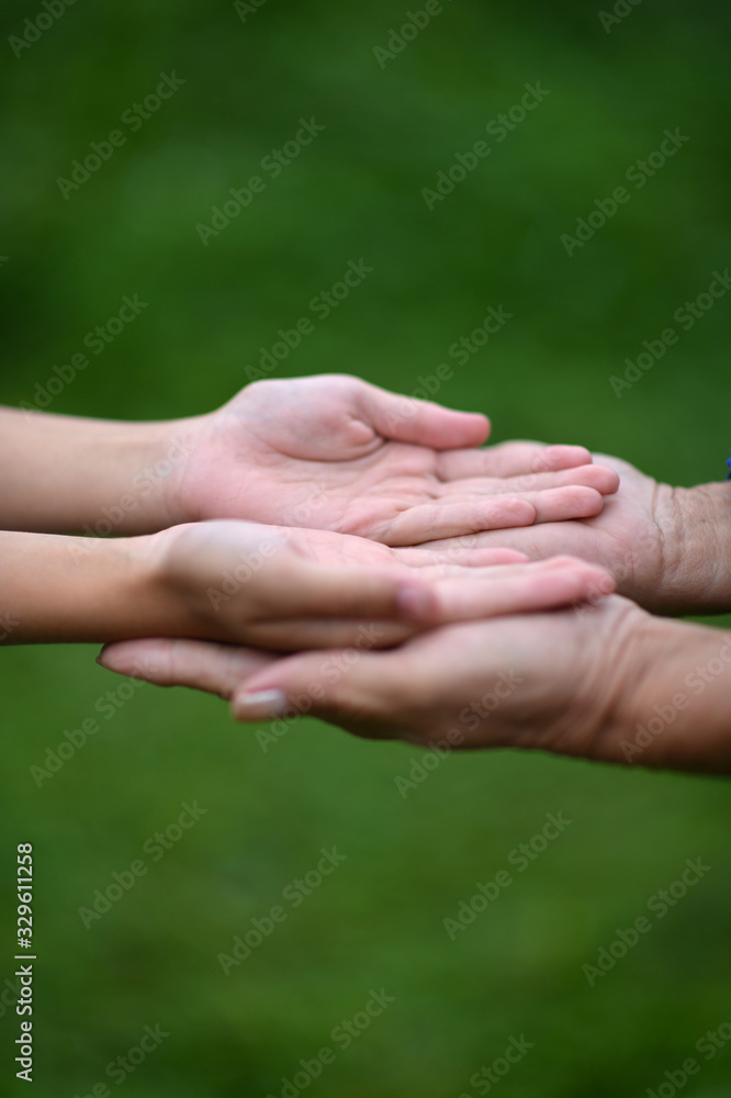 A couple holding hands together close up A couple holding hands together close up