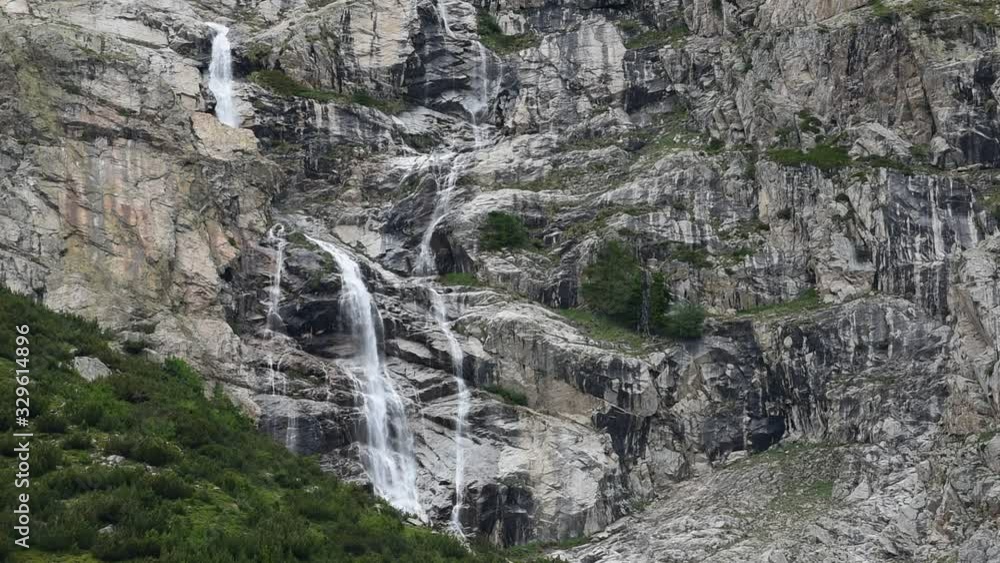 Waterfall in the Mount Blanc massif seen from Val Veny, Alps, Italy Waterfall in the Mount Blanc massif seen from Val Veny, Alps, Italy