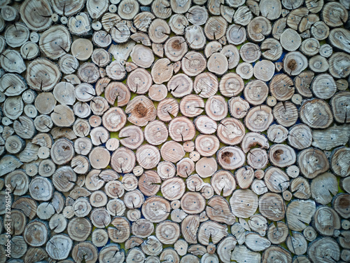 Lots of aged cracked wooden circular tree section with rings and texture placed on stone table with copy space