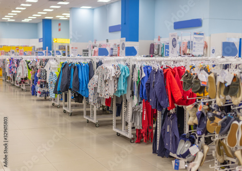 in the mall children's clothes and shoes of different sizes on hangers and racks for sale