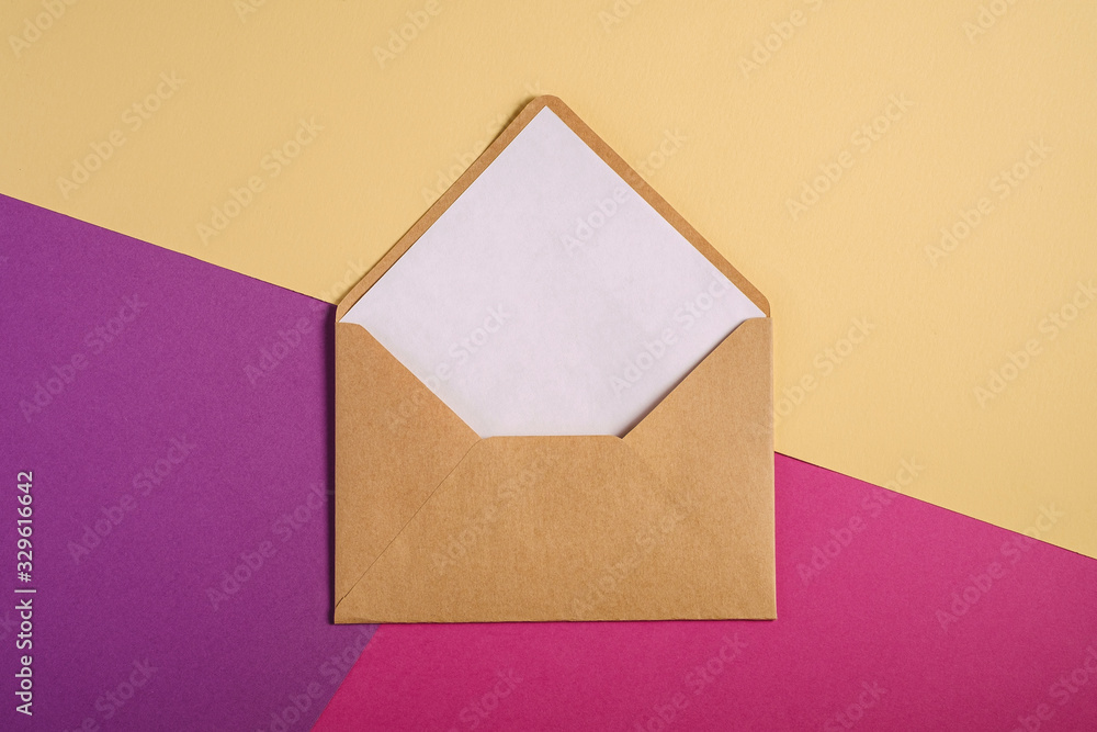 Kraft brown paper envelope with white empty card, pink, purple and cream yellow background, mockup blank letter Kraft brown paper envelope with white empty card, pink, purple and cream yellow background, mockup blank letter