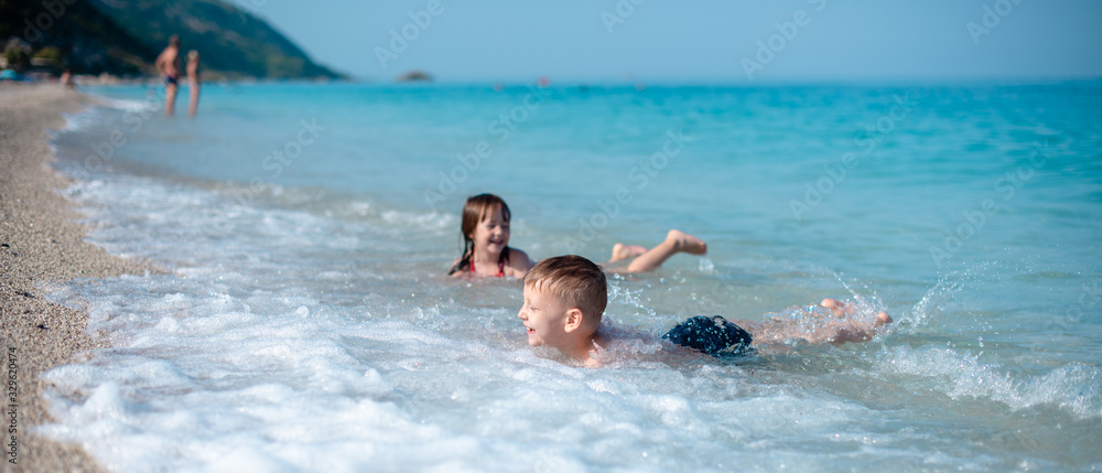 Siblings are playing on the beach