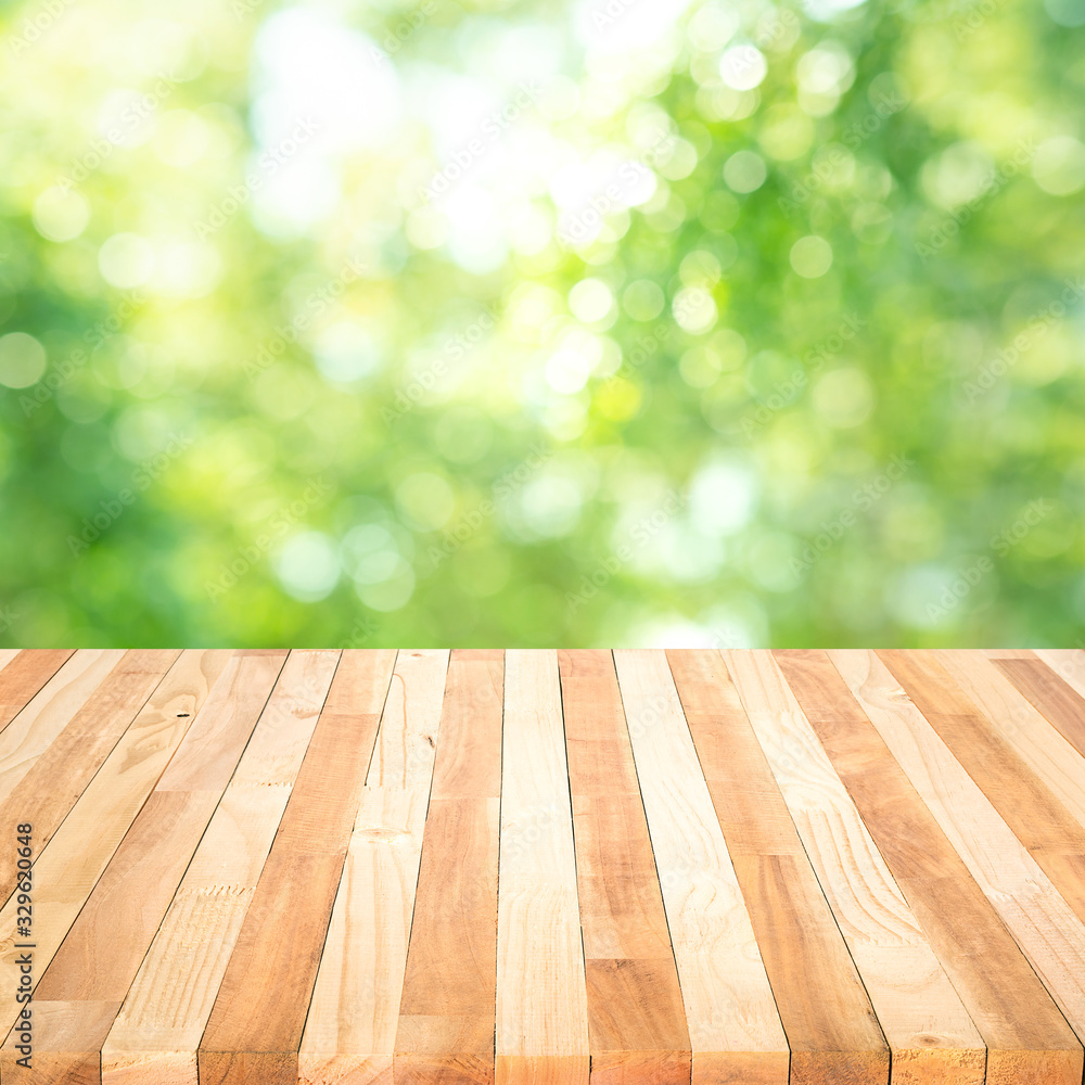 Real wood table top texture on blur leaf tree garden background.For create product display Real wood table top texture on blur leaf tree garden background.For create product display