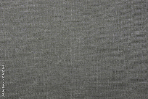 The texture of the rough fabric is gray. Canvas texture background. background. Closeup