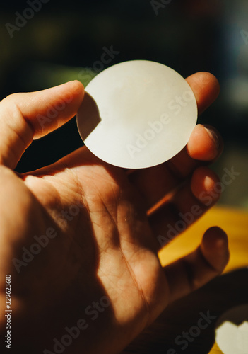 Cardboard round paper in hand. Copy space