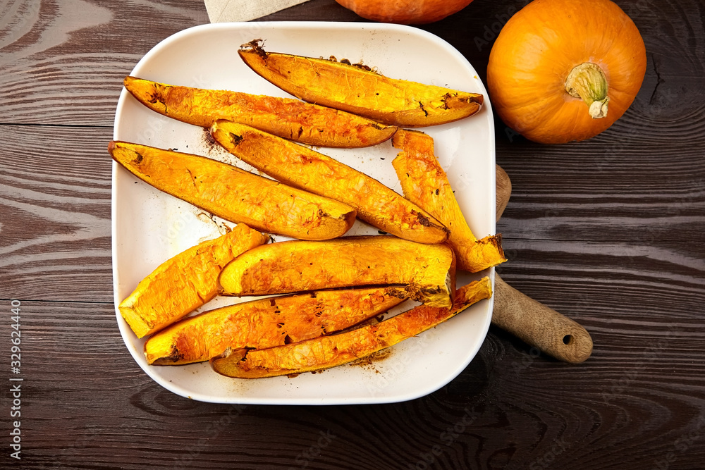 Slices of baked pumpkin in white ceramic bowl Slices of baked pumpkin in white ceramic bowl