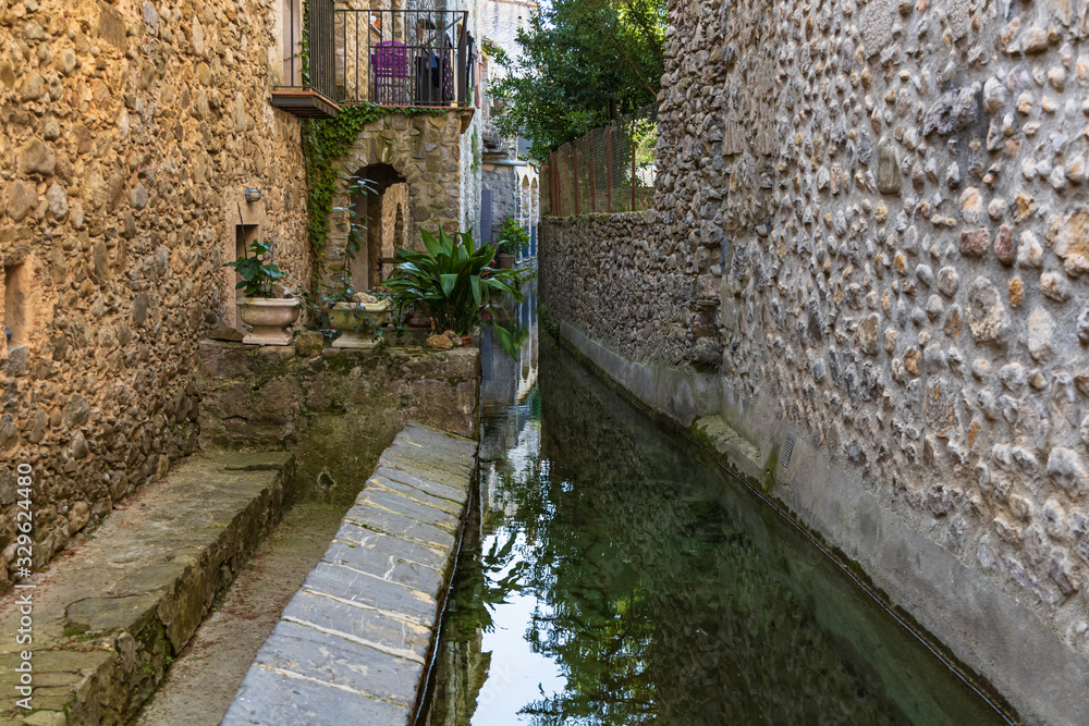 View of the canal that crosses the historic center of St Llorenzo of La Muga.