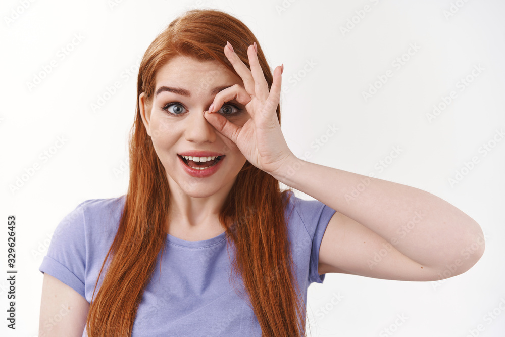 Dreamy impressed cheerful, pretty redhead woman with long ginger hair,looking through okay, ok gesture see something wonderful and amusing, smiling astonished, white background Dreamy impressed cheerful, pretty redhead woman with long ginger hair,looking through okay, ok gesture see something wonderful and amusing, smiling astonished, white background