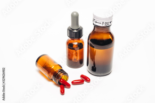 Various medical bottle  brown glass pharmacy bottle  opened bottle with spilled pills isolated in white background 