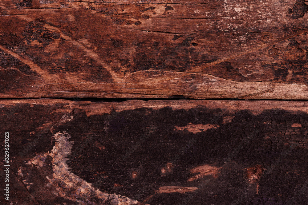 Fototapeta premium Dark brown wooden wall background. Rough panel surface material for vintage wallpaper concept.