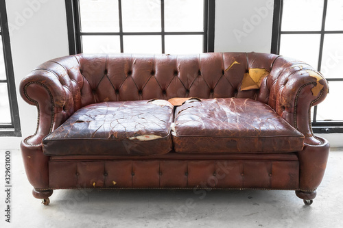 vintage style . Defective old leather sofa on white room