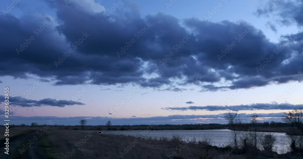 EC4 Evening Colorful Cloudscape and Sunset above Field, Plains, Grove and River. Wind Blowing Dramatic Clouds. Rural Countryside Landscape. Season change Autumn, Winter, Spring EC4 Evening Colorful Cloudscape and Sunset above Field, Plains, Grove and River. Wind Blowing Dramatic Clouds. Rural Countryside Landscape. Season change Autumn, Winter, Spring