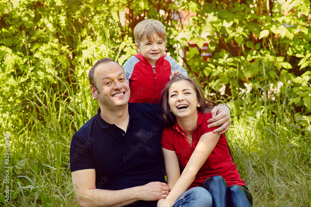 outdoor portrait of a happy family. Mom, dad and child.