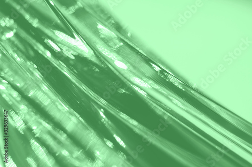 Abstract blurred soft focused futuristic wavy background. Trendy mint colored minimal backdrop. Glass texture