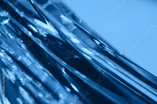 Abstract blurred soft focused futuristic dark blue glass wavy background. 2020 trend color concept photo