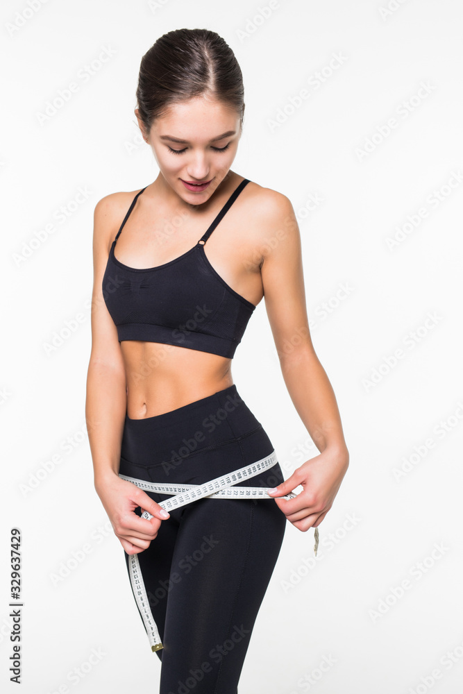 Fitness woman measuring perfect shape of beautiful hips isolated on white background. Healthy lifestyles concept Fitness woman measuring perfect shape of beautiful hips isolated on white background. Healthy lifestyles concept