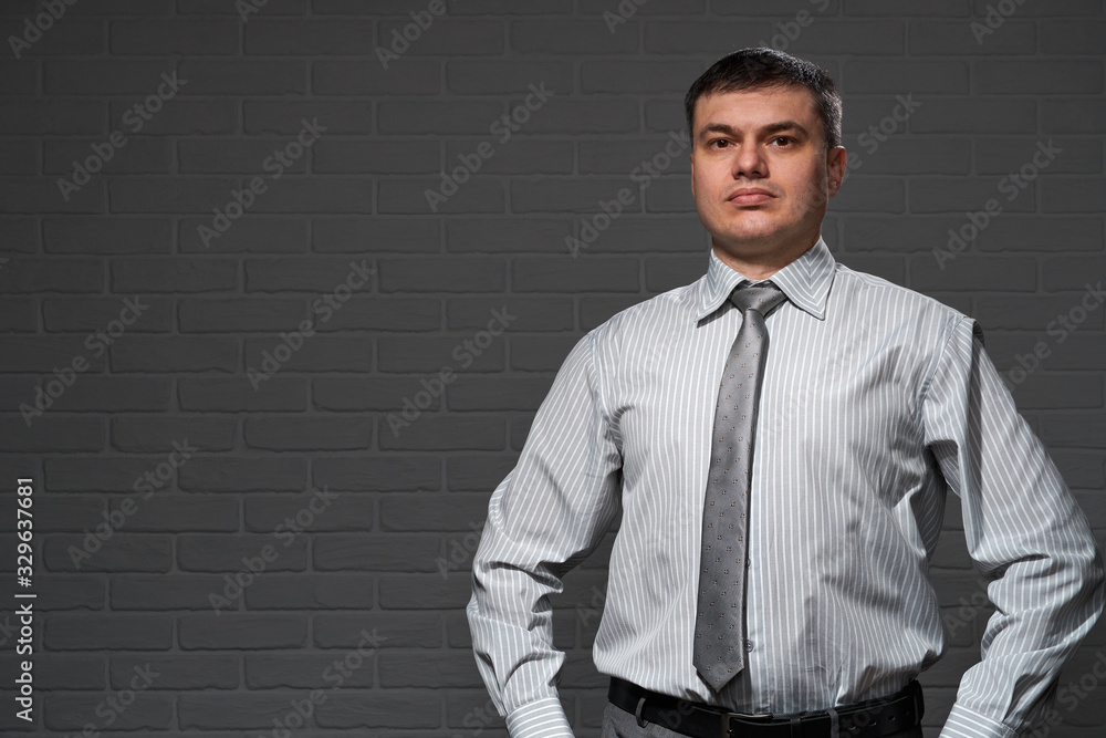 Businessman closeup portrait, dark wall background Businessman closeup portrait, dark wall background