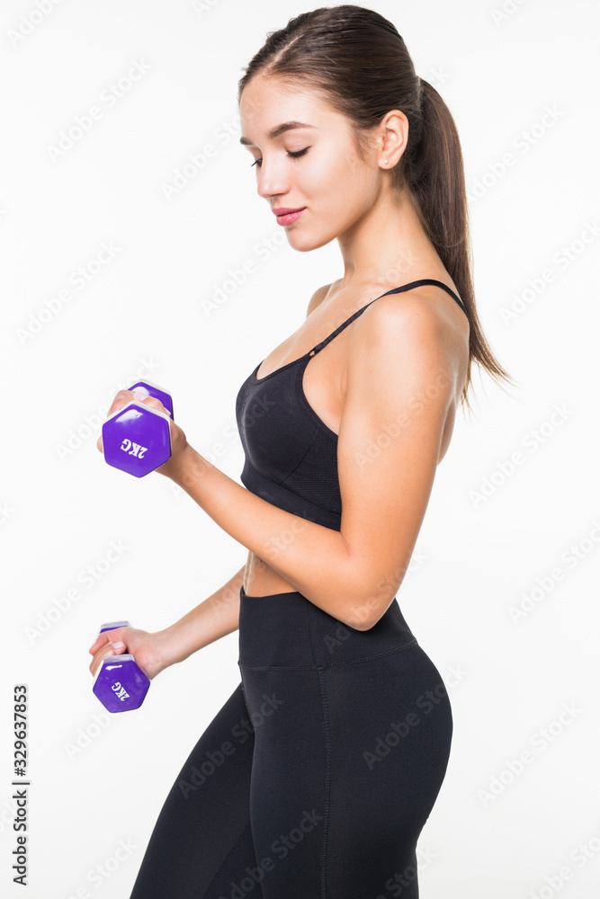 Young fitness woman working out with dumbbell isolated white background Young fitness woman working out with dumbbell isolated white background