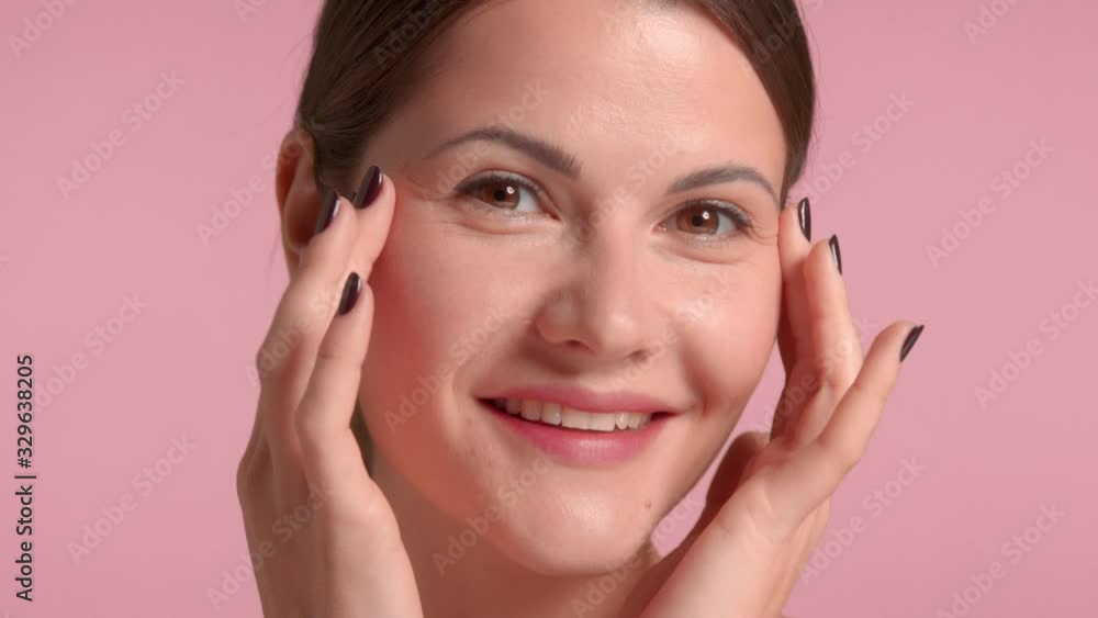 30s brunette woman makes some under eye tap massage Self care concept 30s brunette woman makes some under eye tap massage Self care concept