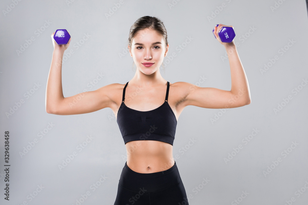 Athletic fitness girl with dumbbells on a white background Athletic fitness girl with dumbbells on a white background