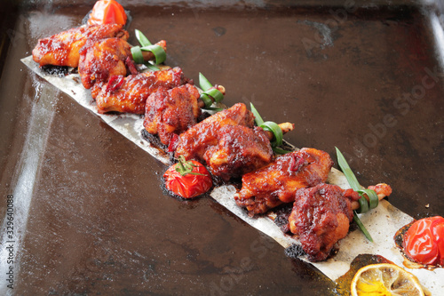  Grilled baked chicken wings with hot chili pepper and soy sauce.