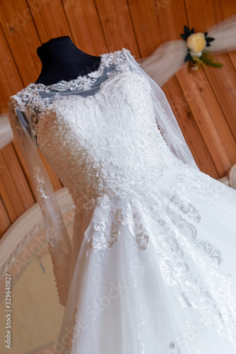 wedding dress in the room of the bride, around flowers and decoration. Wedding day