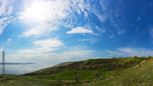 Fototapeta Naklejka Na Ścianę i Meble -  Mountain sea shore in the fall against the blue sky with clouds.