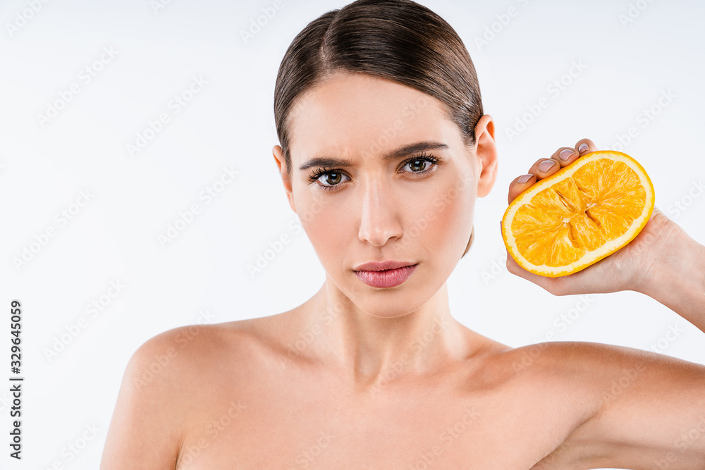 Serious caucasian woman with orange in hand isolate over background. Beauty concept Serious caucasian woman with orange in hand isolate over background. Beauty concept