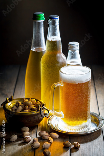 Light beer in a glass on a table in composition with accessories on an old background