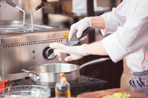 chef cooks spaghetti in a premium restaurant.