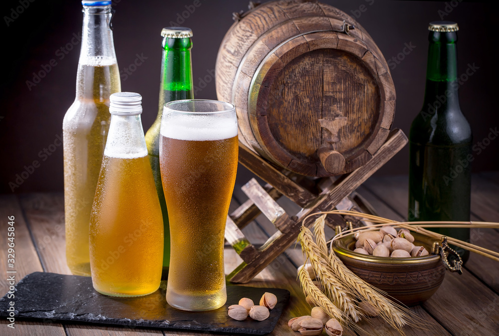 Light beer in a glass on a table in composition with accessories on an old background Light beer in a glass on a table in composition with accessories on an old background