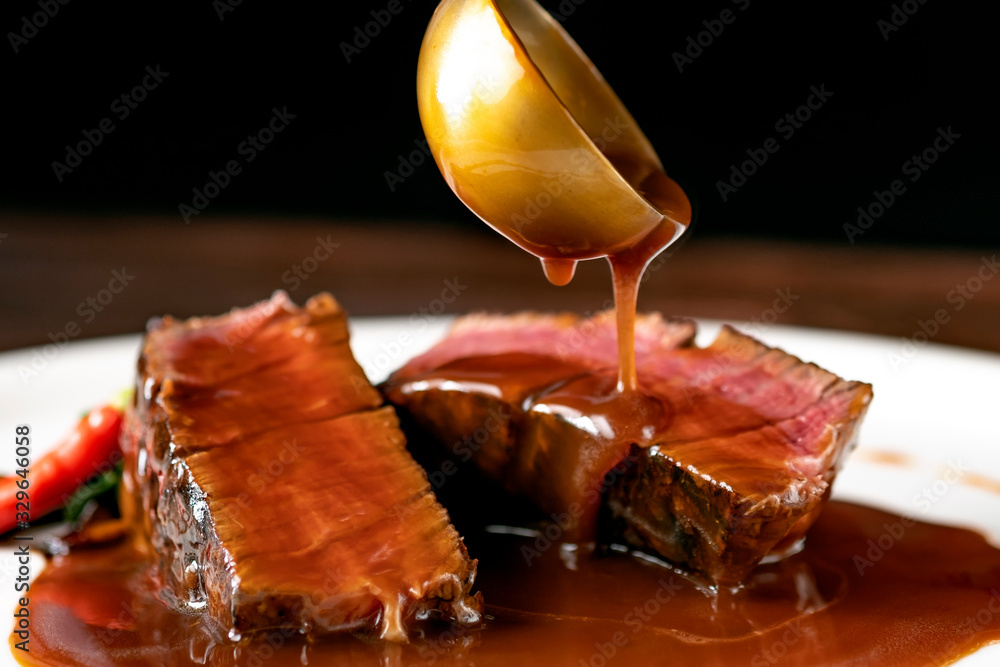Grilled beef Steak filet Mignon medium rare pour demi-glace sauce - obrazy, fototapety, plakaty 