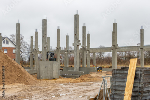  large construction site many concrete columns are placed with the help of a crane