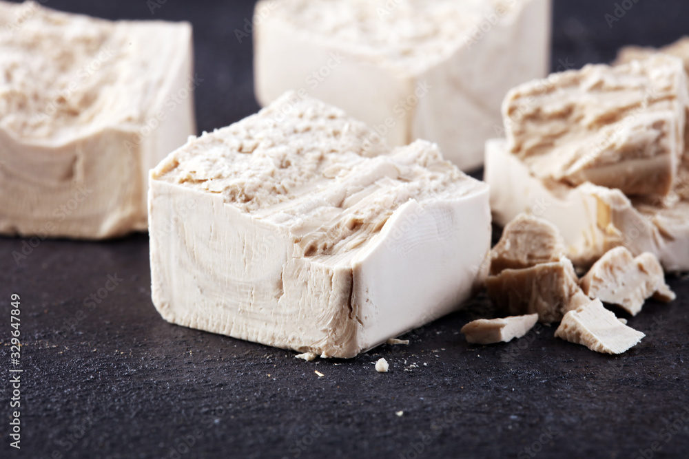 Dry yeast crumbled and yeast block for baking on background Dry yeast crumbled and yeast block for baking on background
