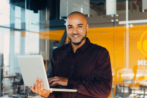 African american businessman sitting at a computer in his startup office