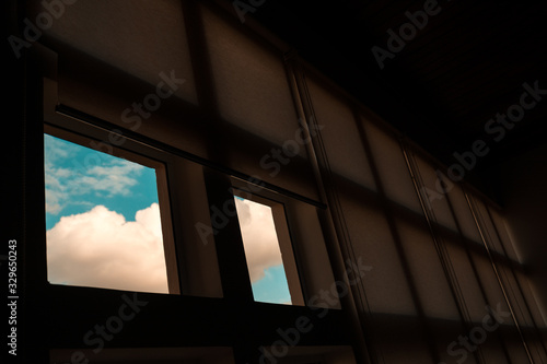 Square windows that shows a clear blue sky at the outside.