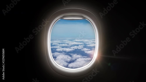 Black background with copy space with look of window seat frame of airplane flight see view of clouds, wing travel during coronavirus risk crisis fall demand of flight cancel 