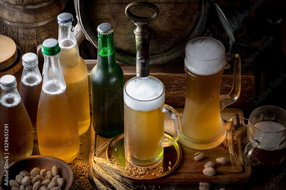 Light frothing beer in a glass, on an old background. Light frothing beer in a glass, on an old background.