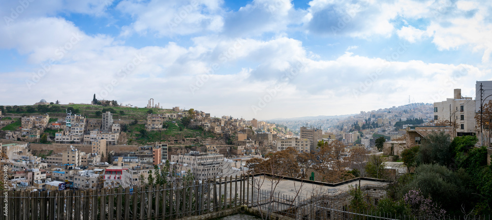 Panoramic cityscape of downtown Amman in Jordan on a sunny day with hills in the background