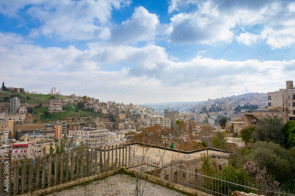Cityscape of downtown Amman in Jordan on a sunny day with hills in the background