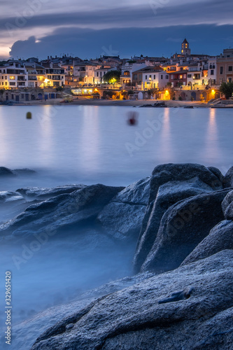 Pueblo marítimo de Calella de Palafrugell de la Costa Brava al atardecer con rocas en primer plano (Cataluña, España) photo