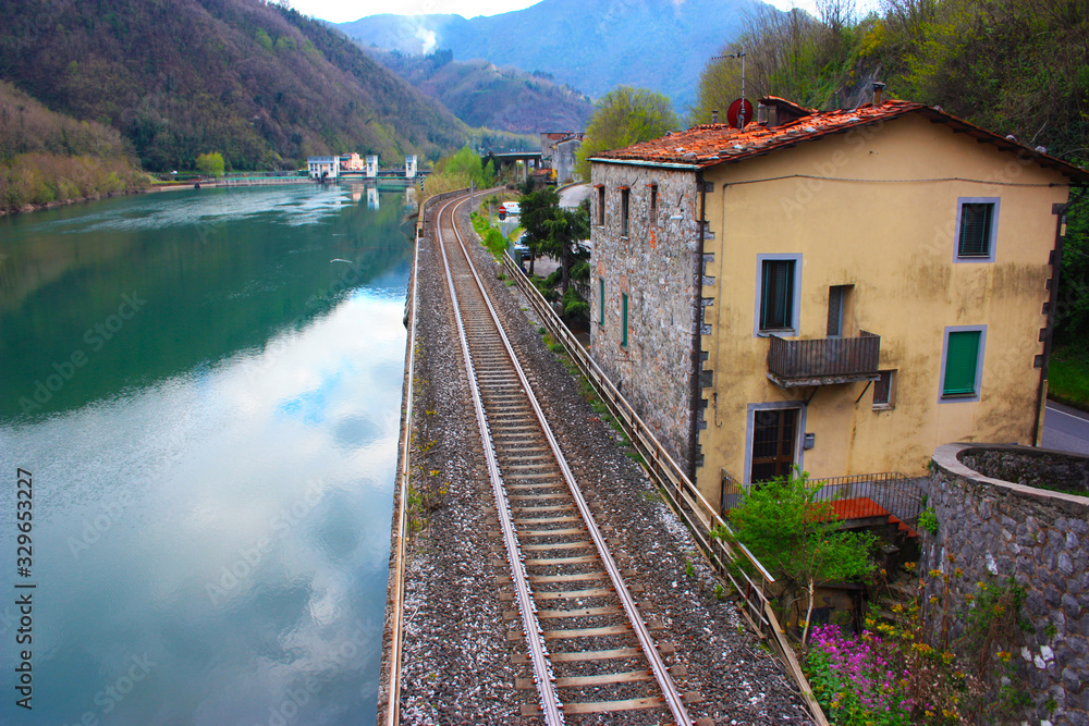 The Tuscan Serchio river in Borgo a Mozzano and the reflection of the sky on a cloudy day