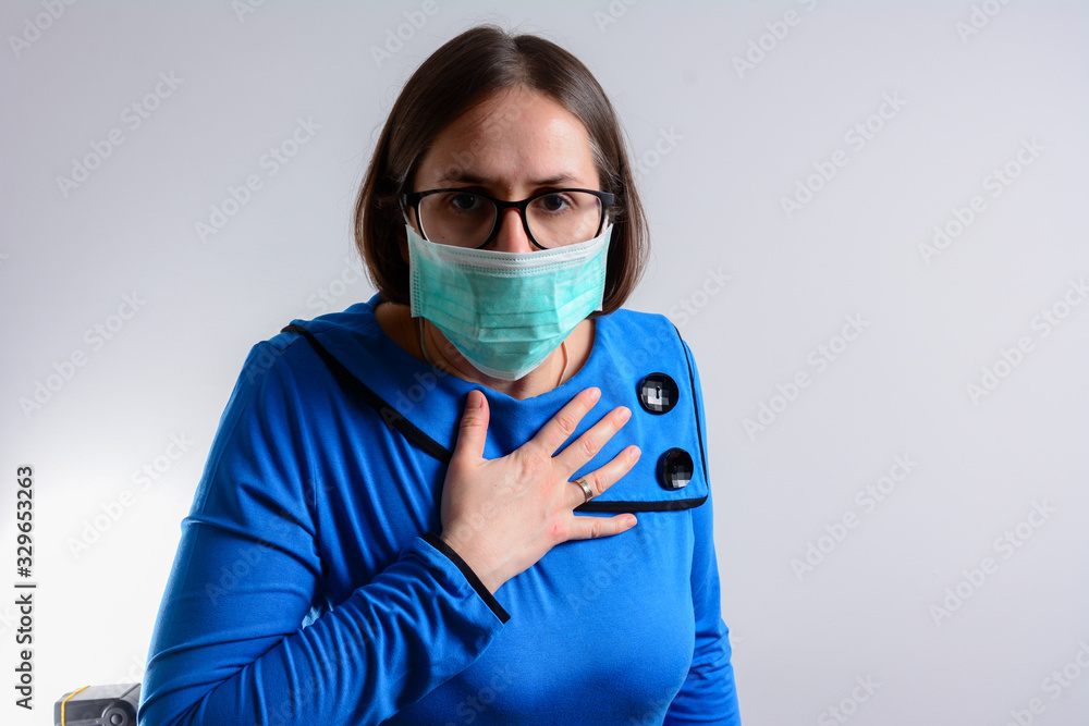 Unhappy woman having breath difficulties in front of white
