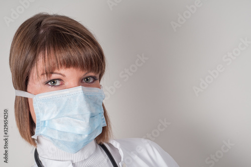 Close up of female doctor with protection mask isolated on white 