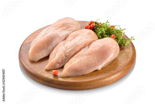 Primal cut of raw chicken breast fillet on a wooden cutting board. Isolated on white background.