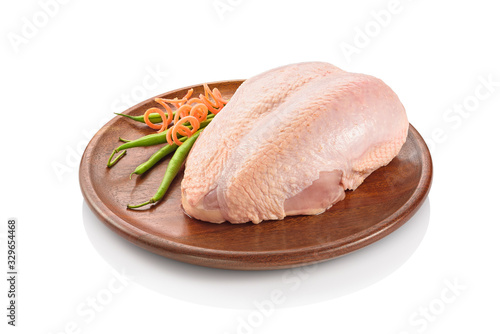 Primal cut of raw chicken breast on a wooden cutting board. Isolated on white background. photo