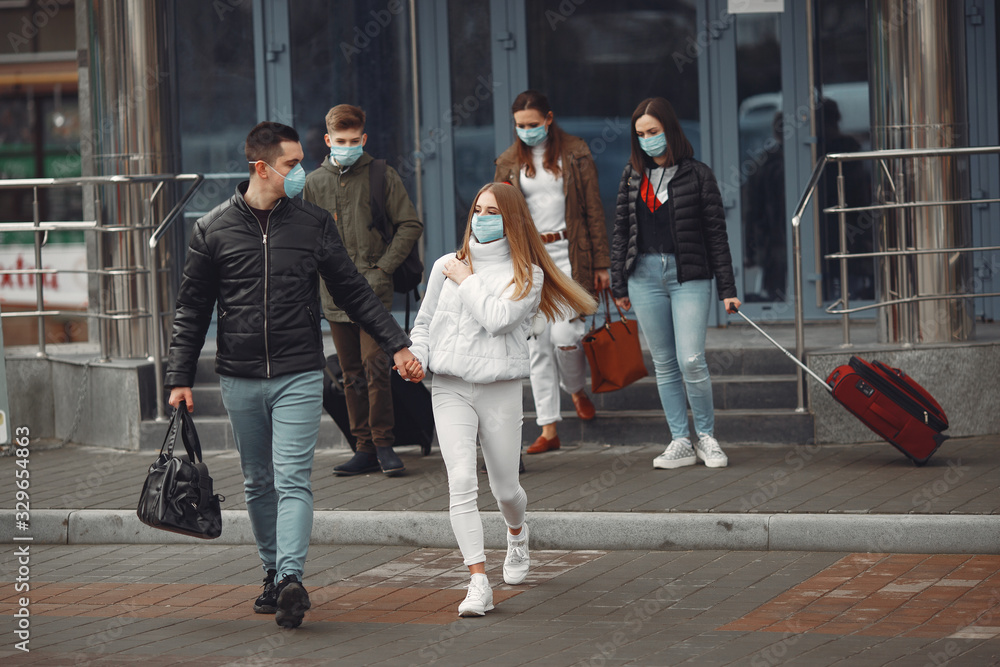 Travelers leaving airport are wearing protective masks. Travelers leaving airport are wearing protective masks.