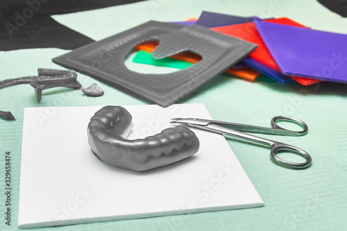 Wallpaper Mural Process of creating custom mouthguard. Silver sports mouthguard with pieces of plastic material and tools. Torontodigital.ca